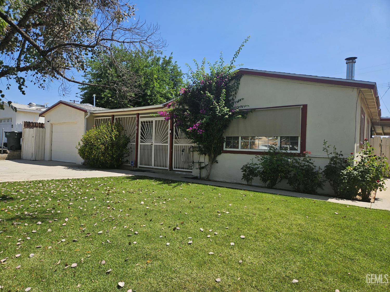 Undisclosed Address Bakersfield, CA 93306 - Photo 3 of 27 a front view of a house with garden