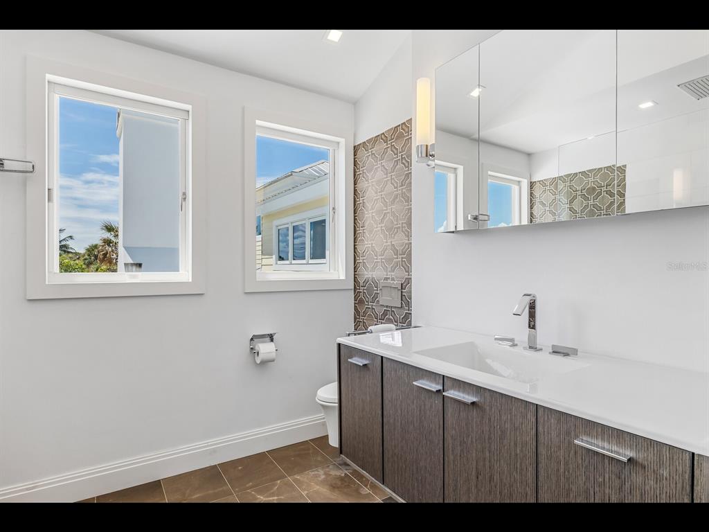 2021 20th Street West Boca Grande, FL 33921 - Photo 23 of 66 a bathroom with a sink and a mirror