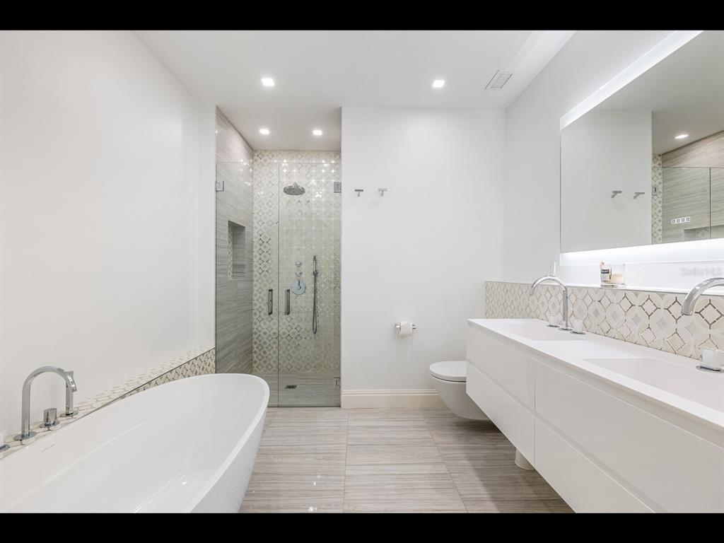 2021 20th Street West Boca Grande, FL 33921 - Photo 34 of 66 a bathroom with a bathtub shower sink vanity and toilet