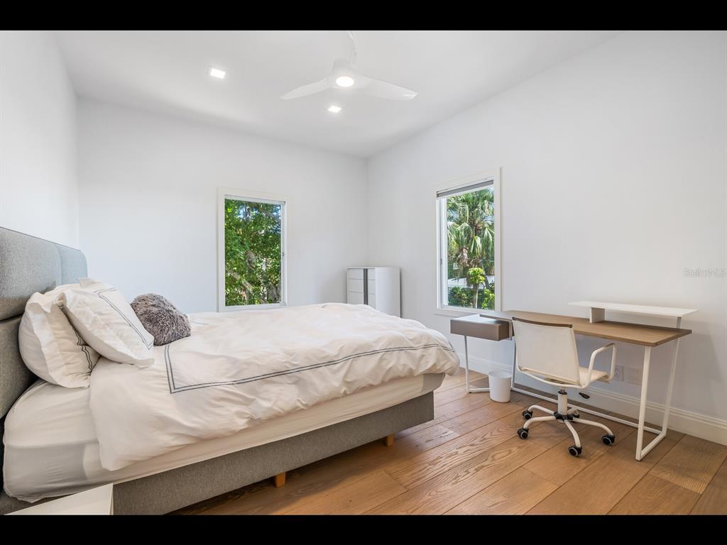 2021 20th Street West Boca Grande, FL 33921 - Photo 35 of 66 a bedroom with a bed and a chair