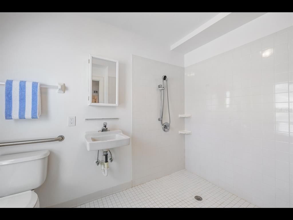 2021 20th Street West Boca Grande, FL 33921 - Photo 36 of 66 a bathroom with a sink a toilet and a mirror