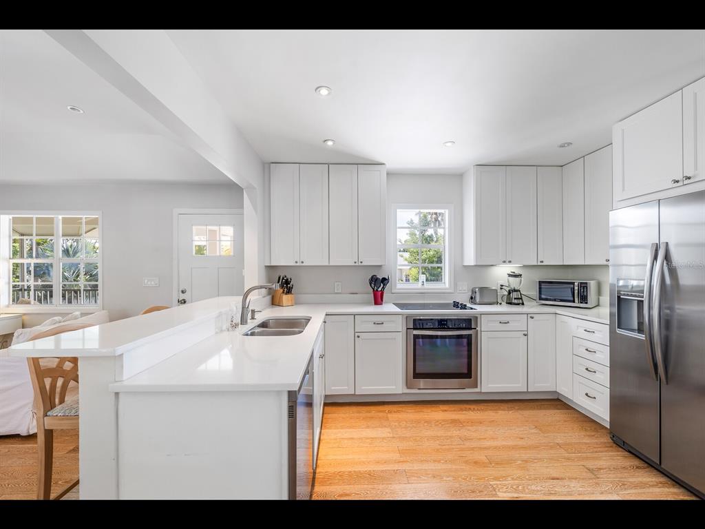 2021 20th Street West Boca Grande, FL 33921 - Photo 43 of 66 a kitchen with a sink cabinets and stainless steel appliances