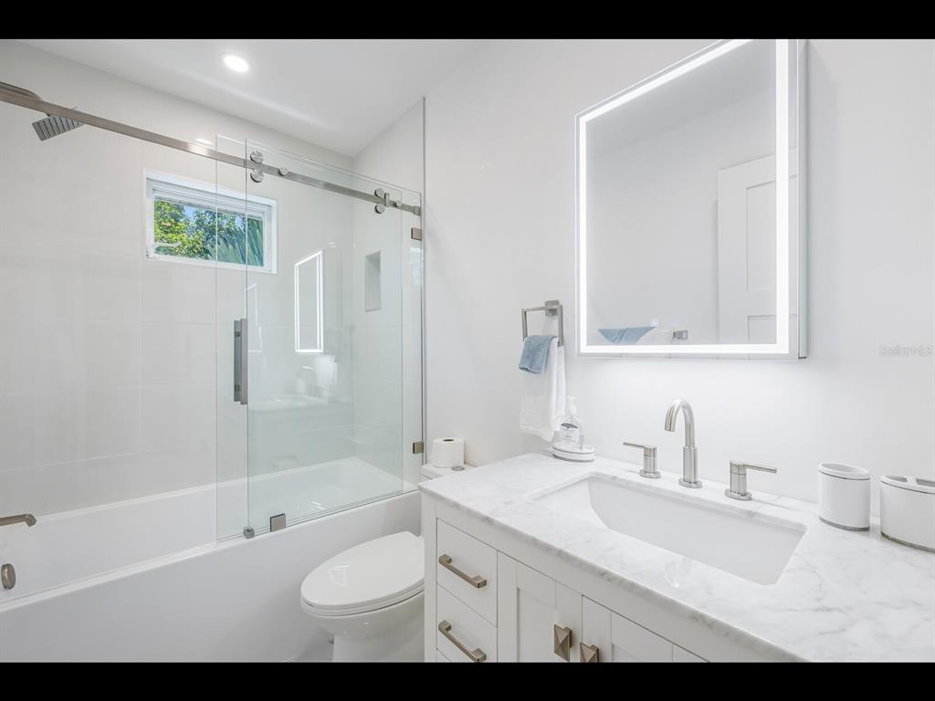 2021 20th Street West Boca Grande, FL 33921 - Photo 52 of 66 a bathroom with a sink a toilet and shower
