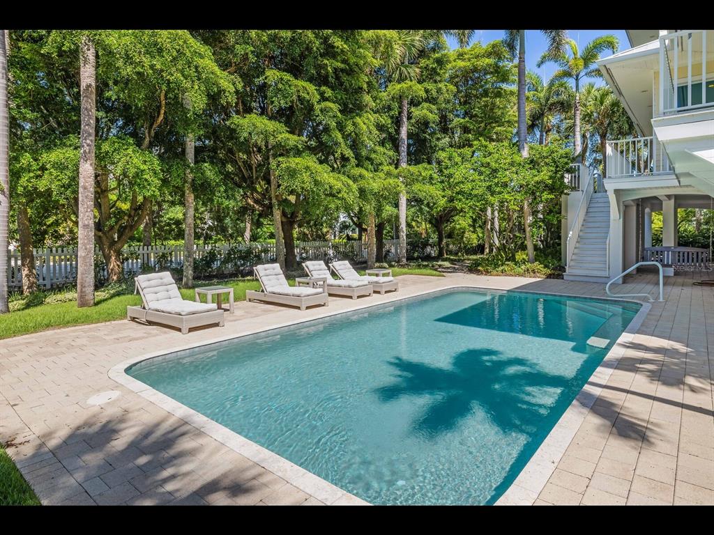 2021 20th Street West Boca Grande, FL 33921 - Photo 54 of 66 a view of a swimming pool with a patio