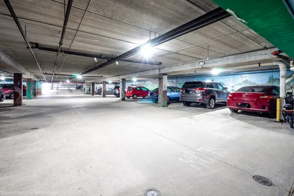 a view of parking garage with cars