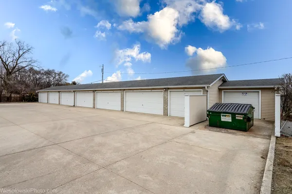 a view of a house with a yard and garage