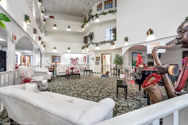 a living room with lots of furniture and a chandelier