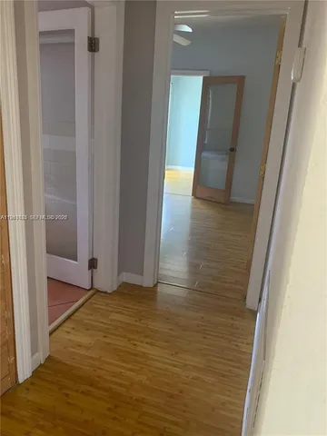 a view of hallway with wooden floor