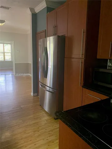 a metallic refrigerator freezer sitting in a kitchen