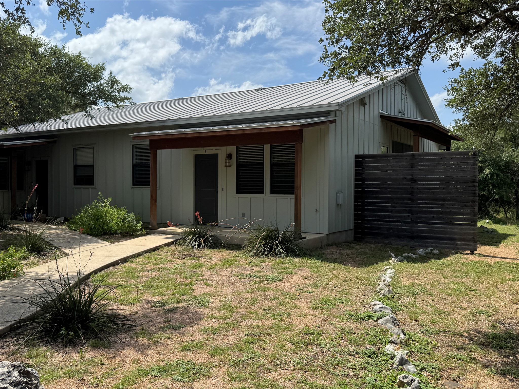 290 Hugo Road, Unit B San Marcos, TX 78666 - Photo 1 of 22 a house with trees in the background