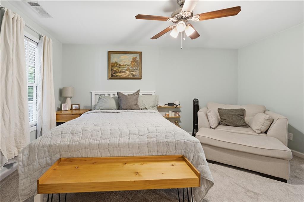 1007 Olde Mill Lane Norcross, GA 30093 - Photo 20 of 32 a bedroom with a bed and a chandelier