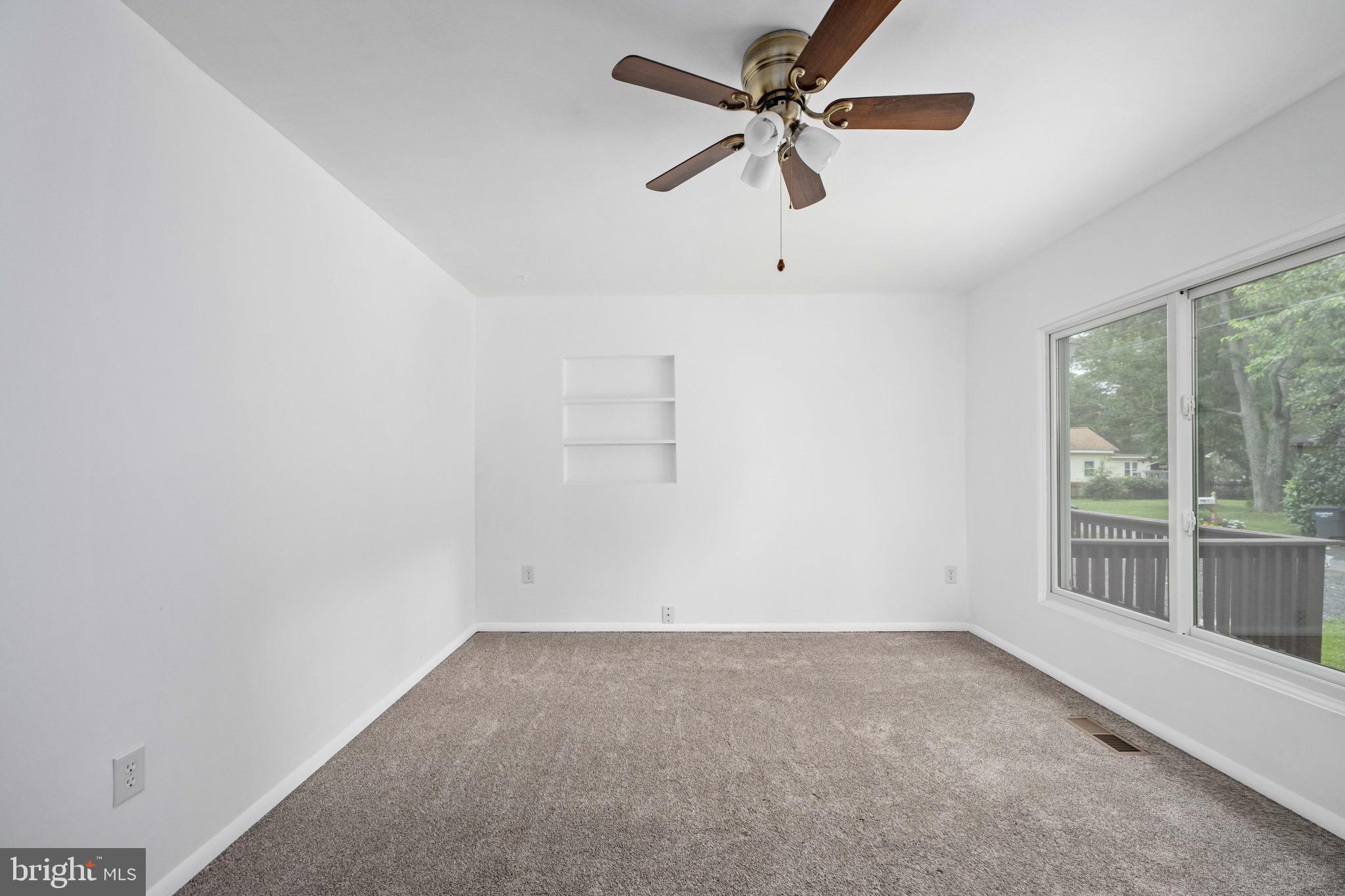 161 8th Street Colonial Beach, VA 22443 - Photo 29 of 71 an empty room with a window and a fan