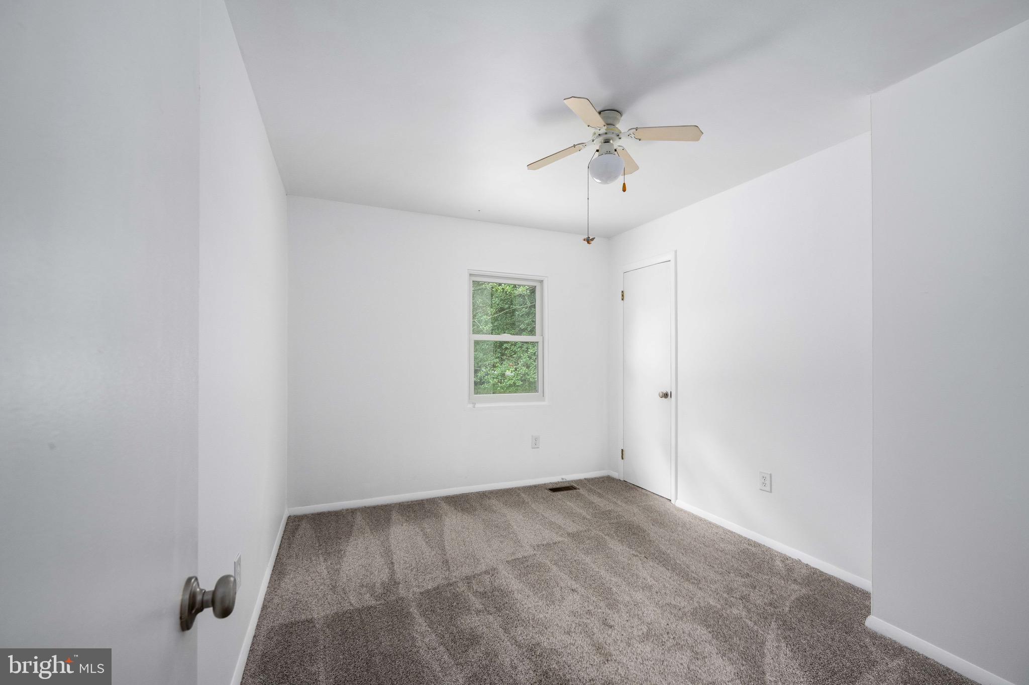 161 8th Street Colonial Beach, VA 22443 - Photo 31 of 71 an empty room with a window and a fan