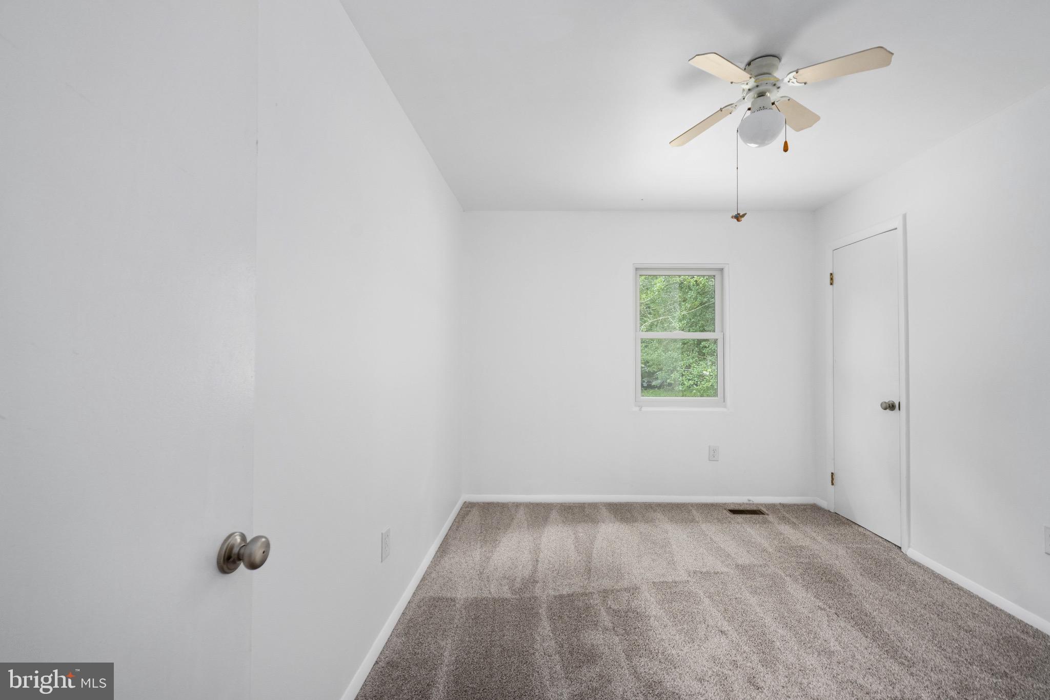 161 8th Street Colonial Beach, VA 22443 - Photo 32 of 71 wooden floor in an empty room with a window