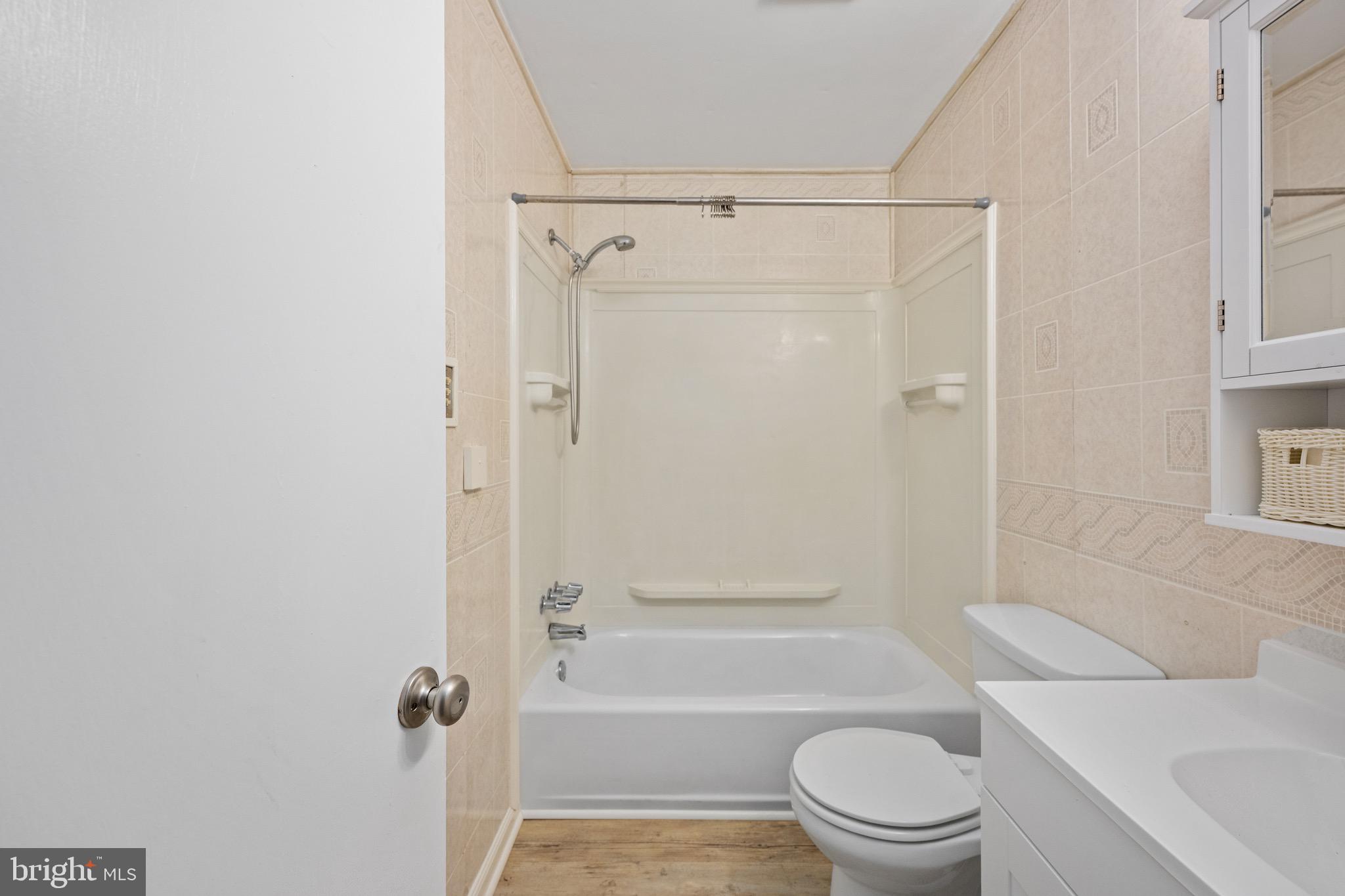 161 8th Street Colonial Beach, VA 22443 - Photo 39 of 71 a bathroom with a toilet a sink and shower