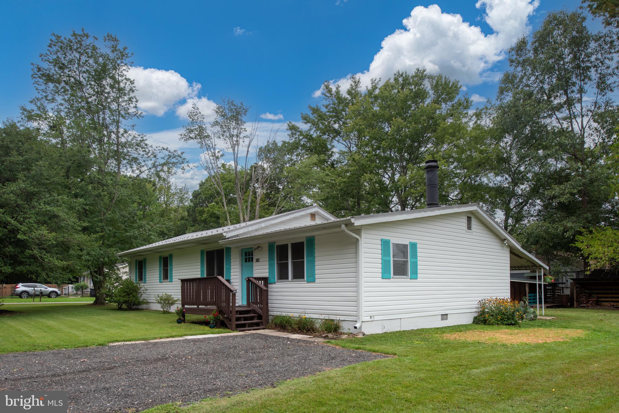161 8th Street Colonial Beach, VA 22443 - Photo 4 of 71 a view of a yard in front of a house with plants and large tree