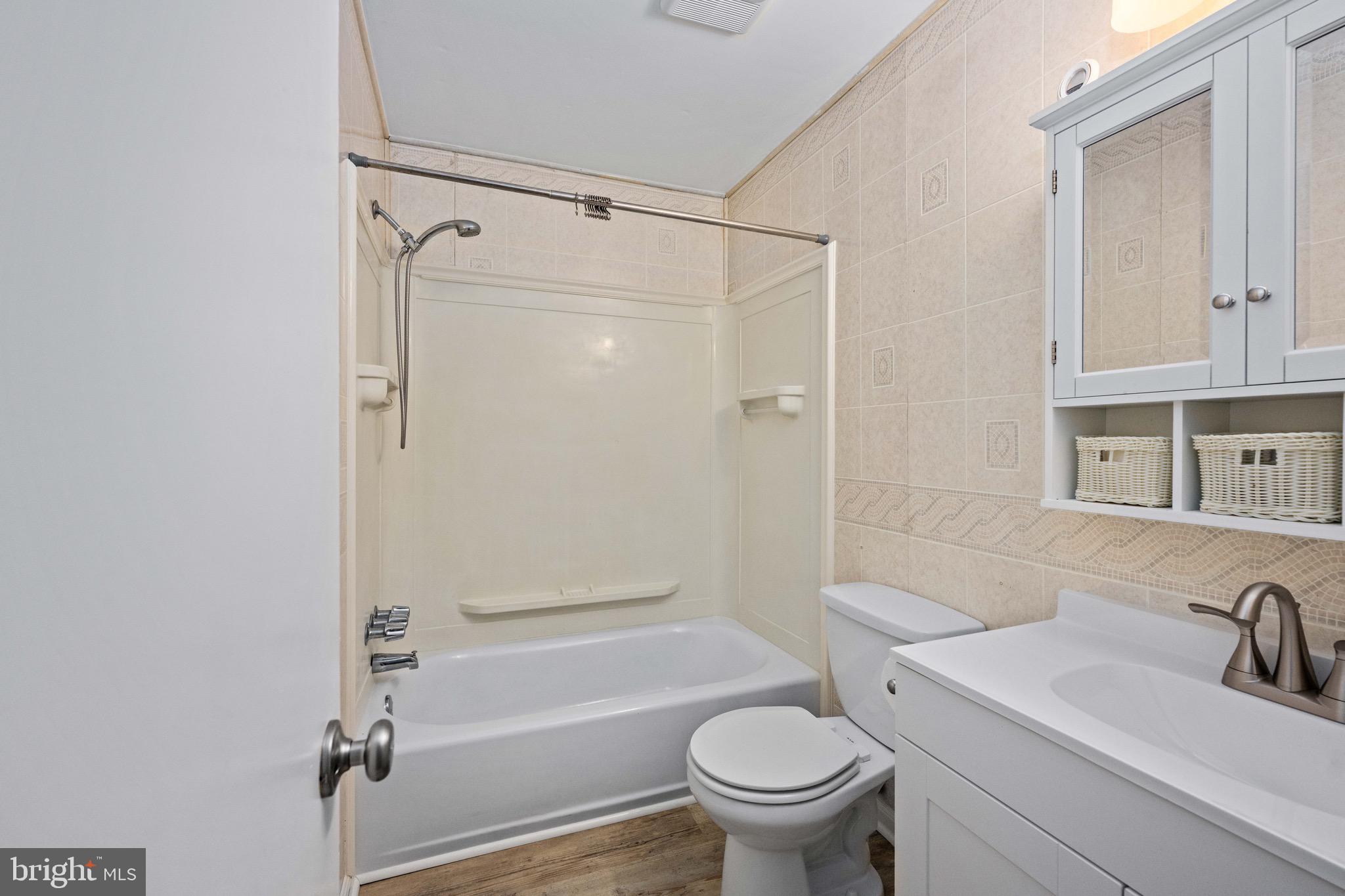 161 8th Street Colonial Beach, VA 22443 - Photo 40 of 71 a bathroom with a sink toilet and shower
