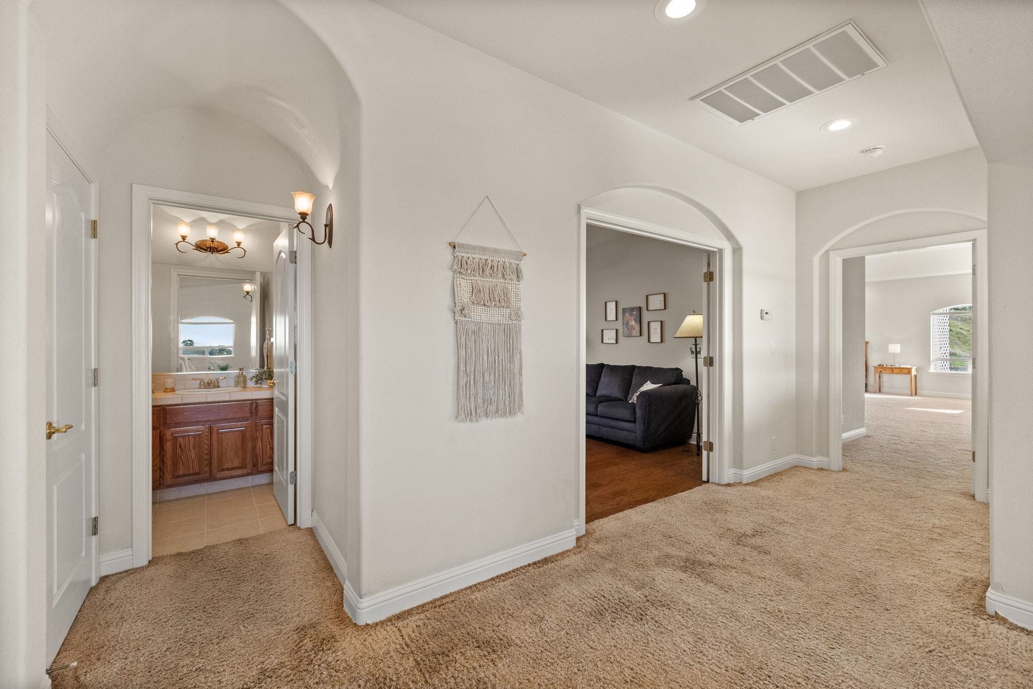 17550 Old Wards Ferry Road Sonora, CA 95370 - Photo 14 of 59 Corridor with light carpet, arched walkways, recessed lighting, and plenty of natural light