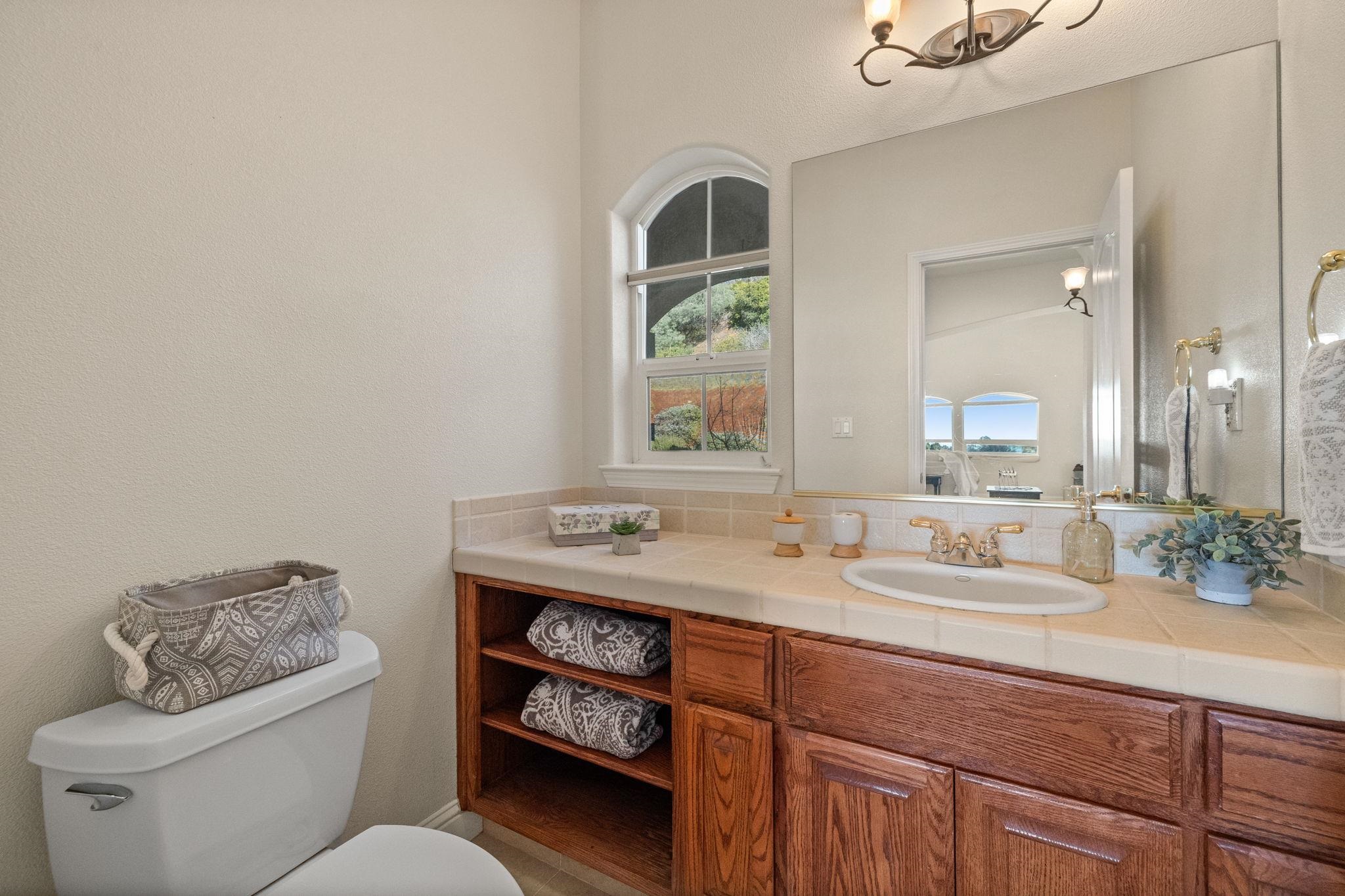 17550 Old Wards Ferry Road Sonora, CA 95370 - Photo 15 of 59 Bathroom featuring vanity, a textured wall, and a chandelier