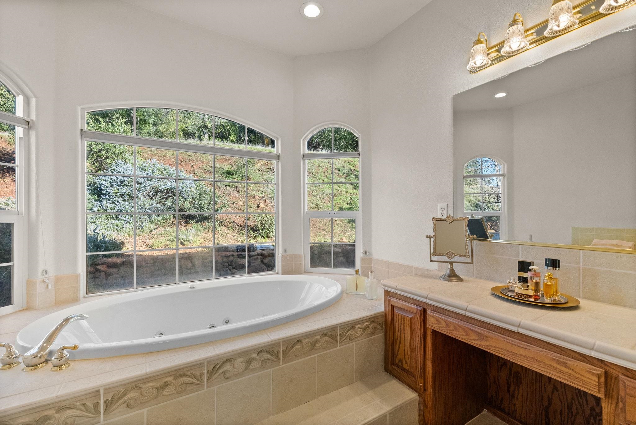 17550 Old Wards Ferry Road Sonora, CA 95370 - Photo 24 of 59 Bathroom featuring a jetted tub, recessed lighting, and vanity