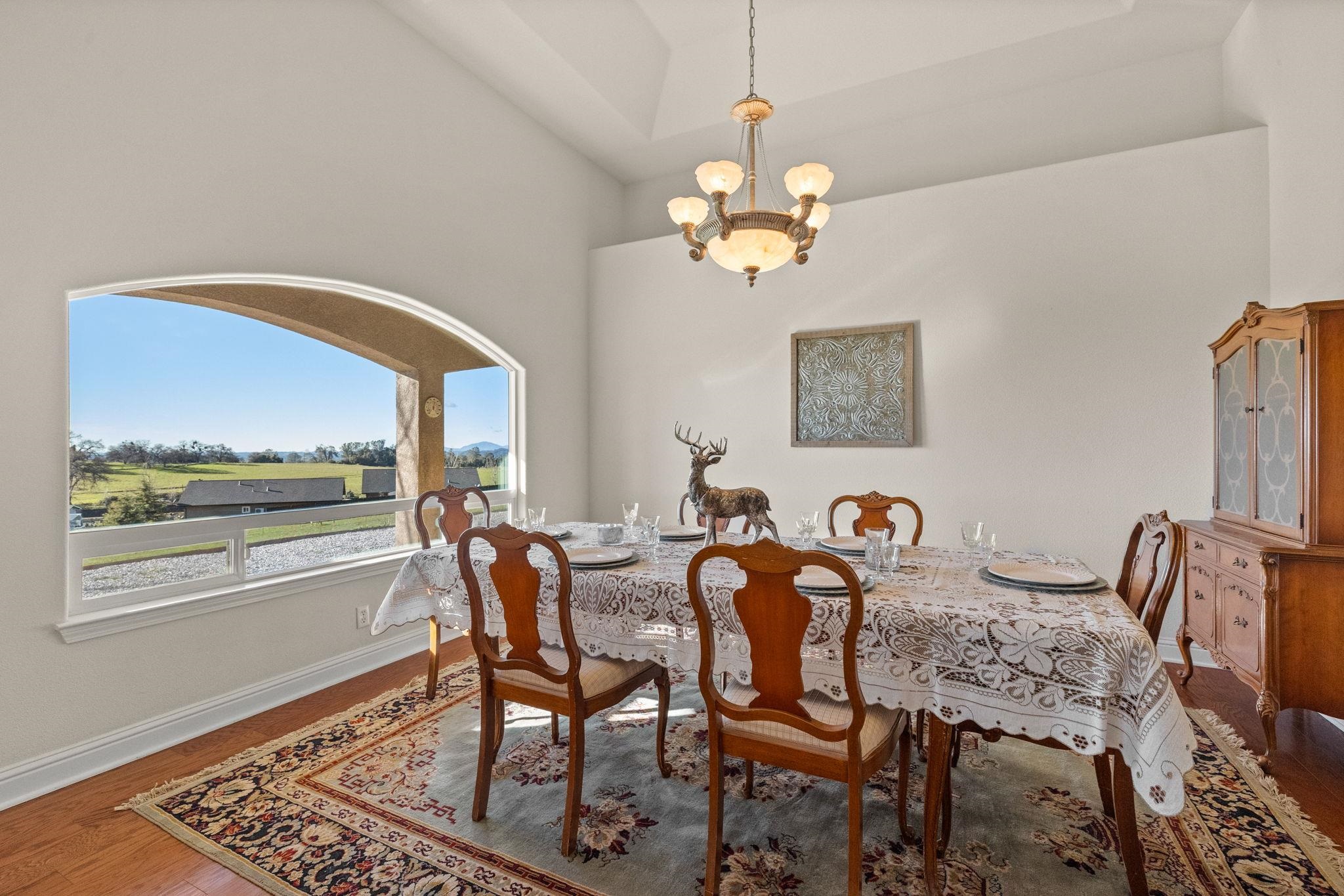 17550 Old Wards Ferry Road Sonora, CA 95370 - Photo 25 of 59 Dining area featuring a chandelier, wood finished floors, and a high ceiling