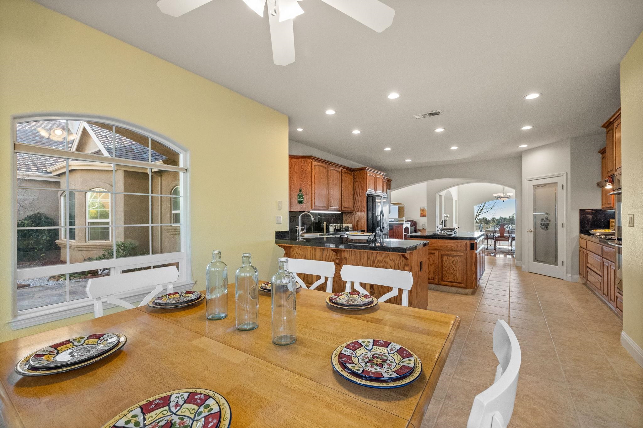 17550 Old Wards Ferry Road Sonora, CA 95370 - Photo 34 of 59 Dining room with arched walkways, recessed lighting, a ceiling fan, and light tile patterned floors