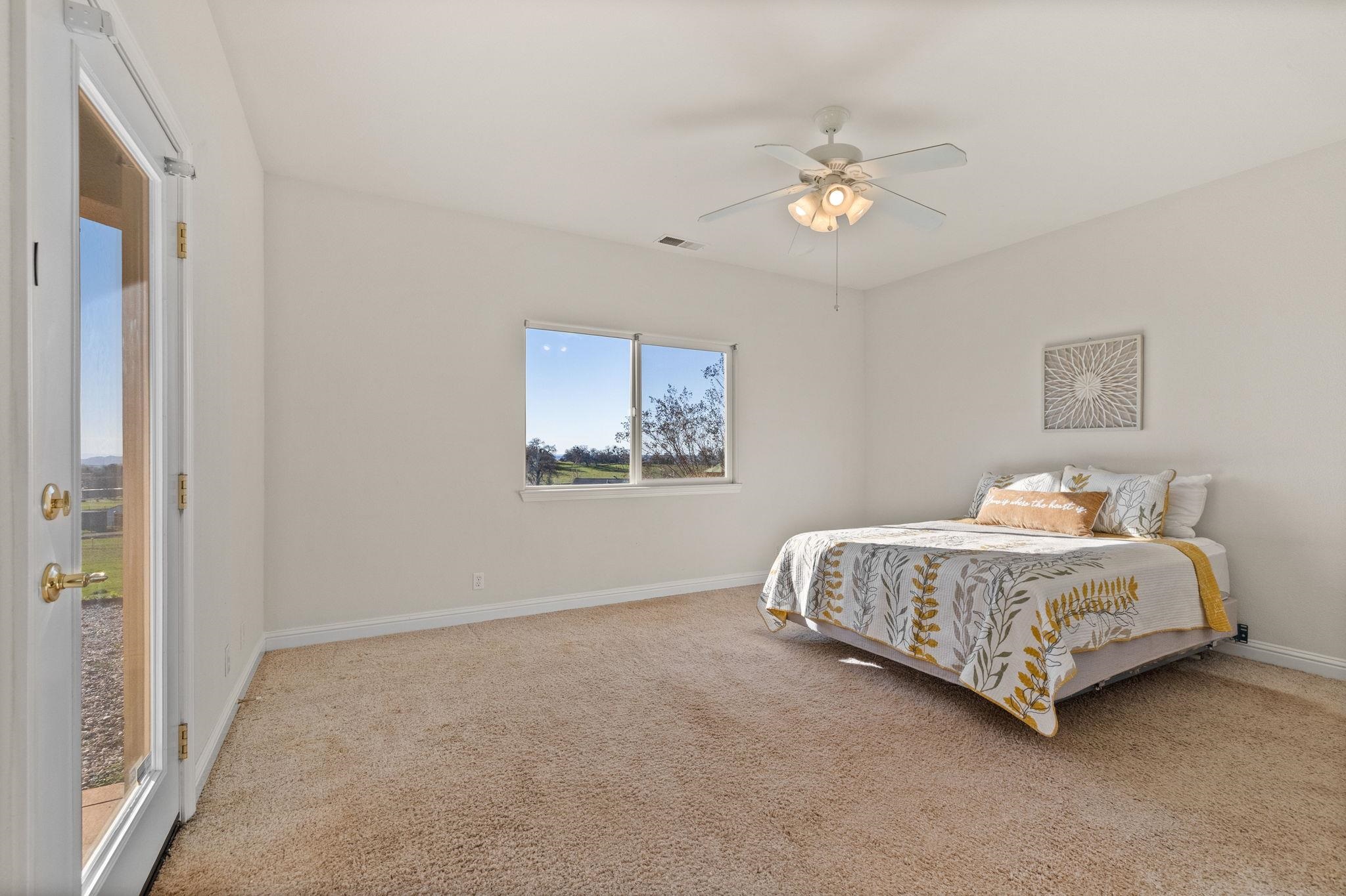 17550 Old Wards Ferry Road Sonora, CA 95370 - Photo 35 of 59 Bedroom with light colored carpet and a ceiling fan