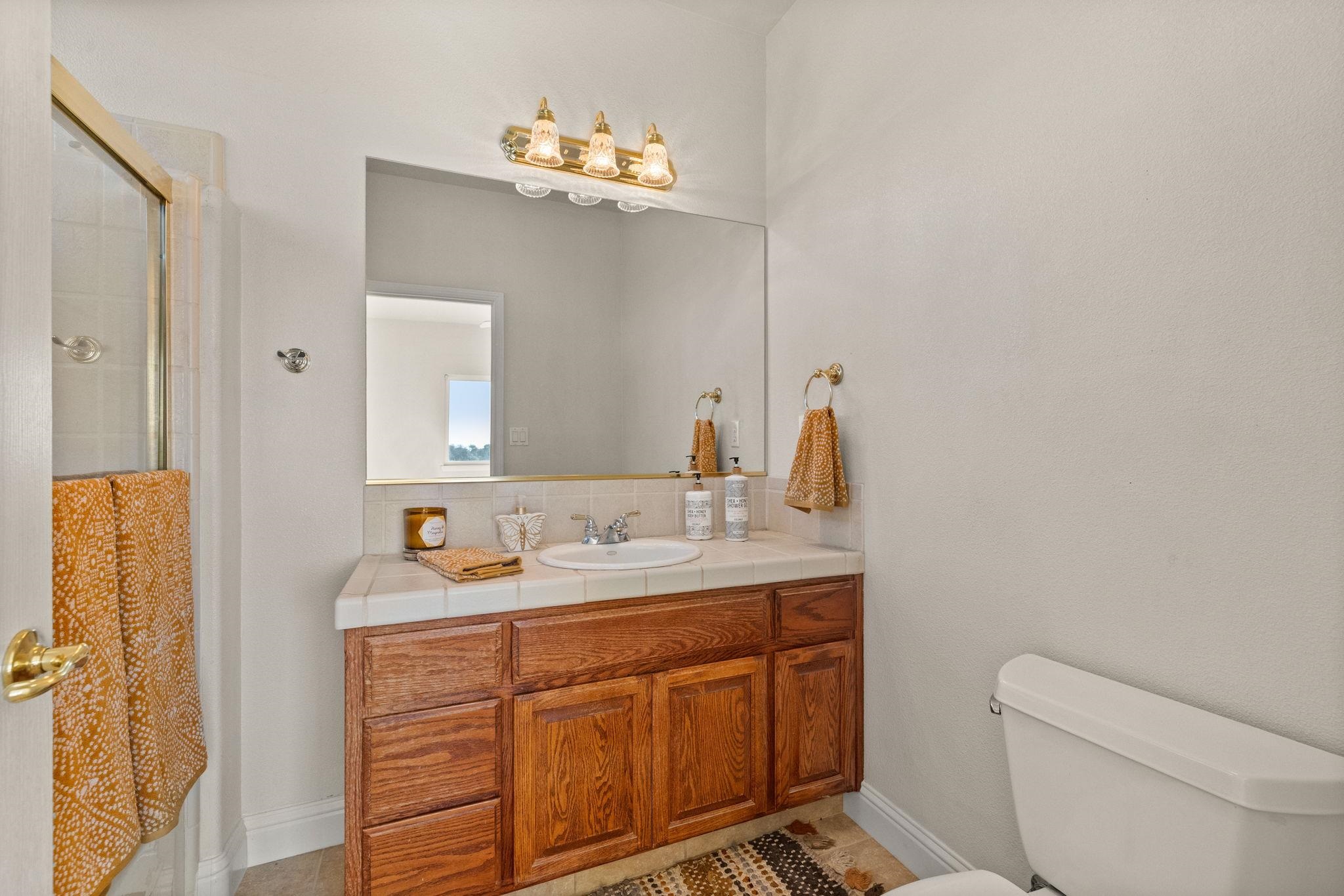 17550 Old Wards Ferry Road Sonora, CA 95370 - Photo 36 of 59 Full bath featuring a stall shower, vanity, and decorative backsplash