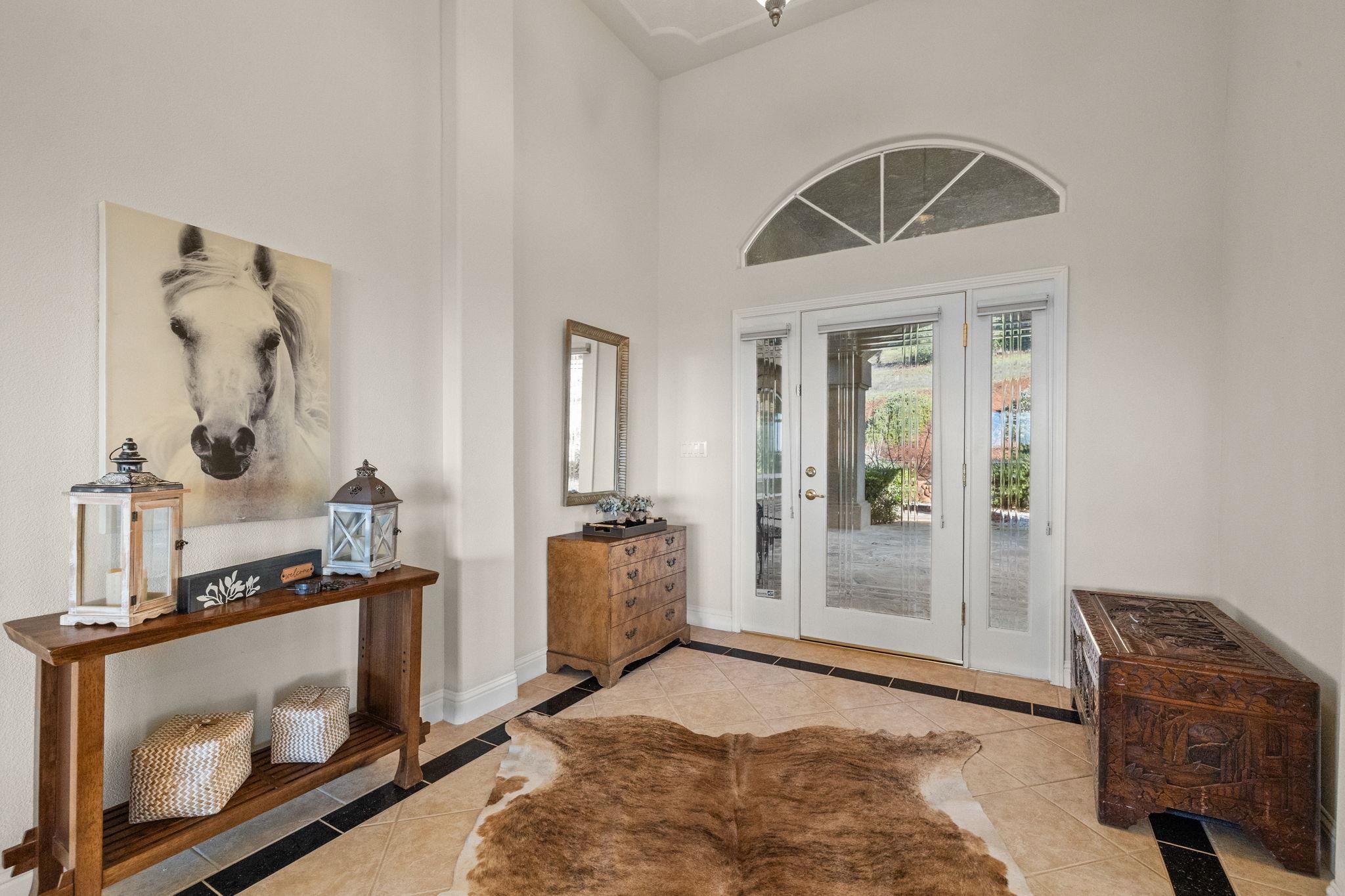17550 Old Wards Ferry Road Sonora, CA 95370 - Photo 7 of 59 Entryway with inlaid floor details, light tile patterned floors, and a high ceiling