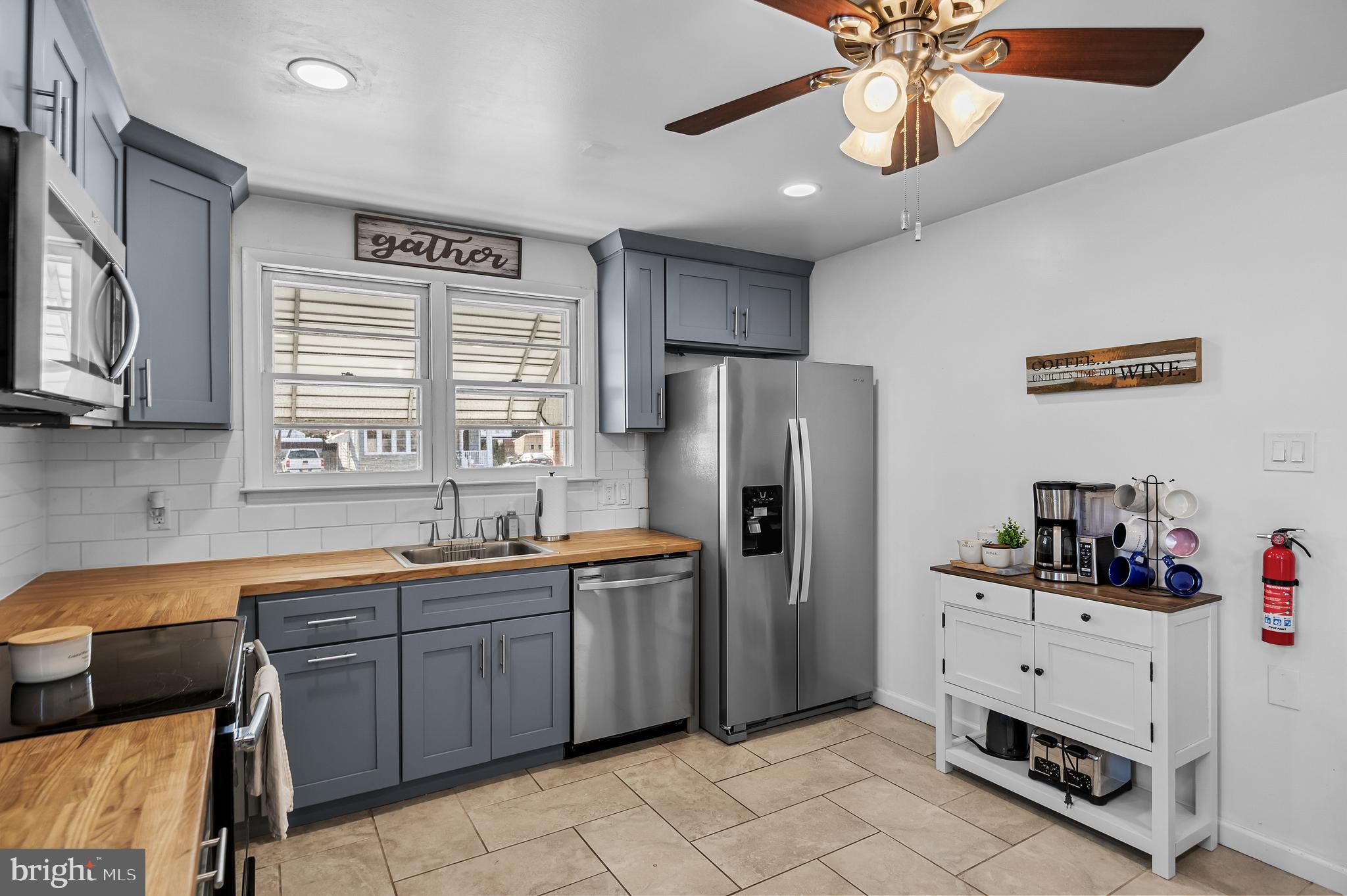 409 Lippincott Avenue Riverside, NJ 08075 - Photo 11 of 25 a kitchen with stainless steel appliances a sink cabinets and refrigerator