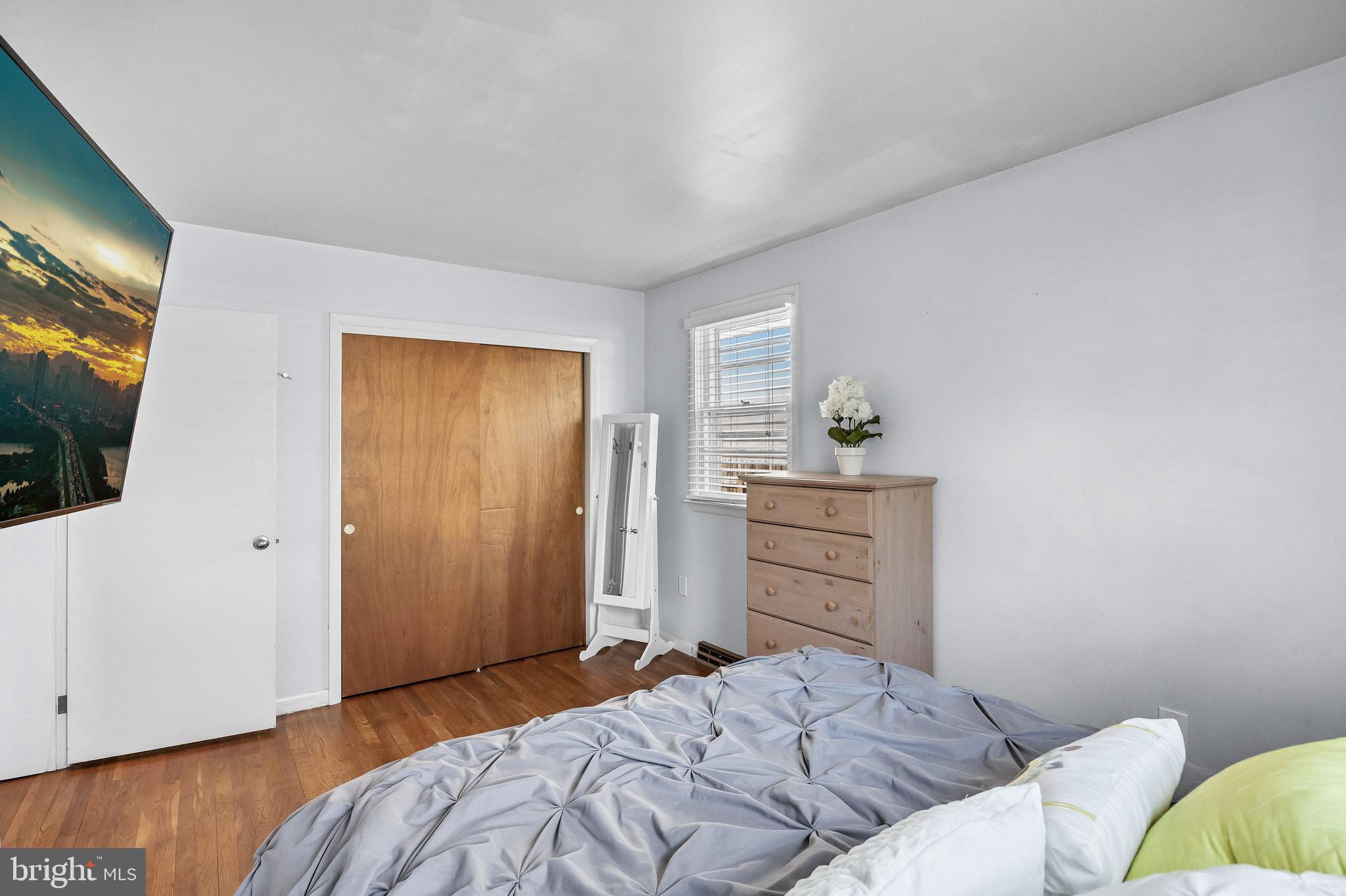 409 Lippincott Avenue Riverside, NJ 08075 - Photo 16 of 25 a bedroom with a bed and wooden floor