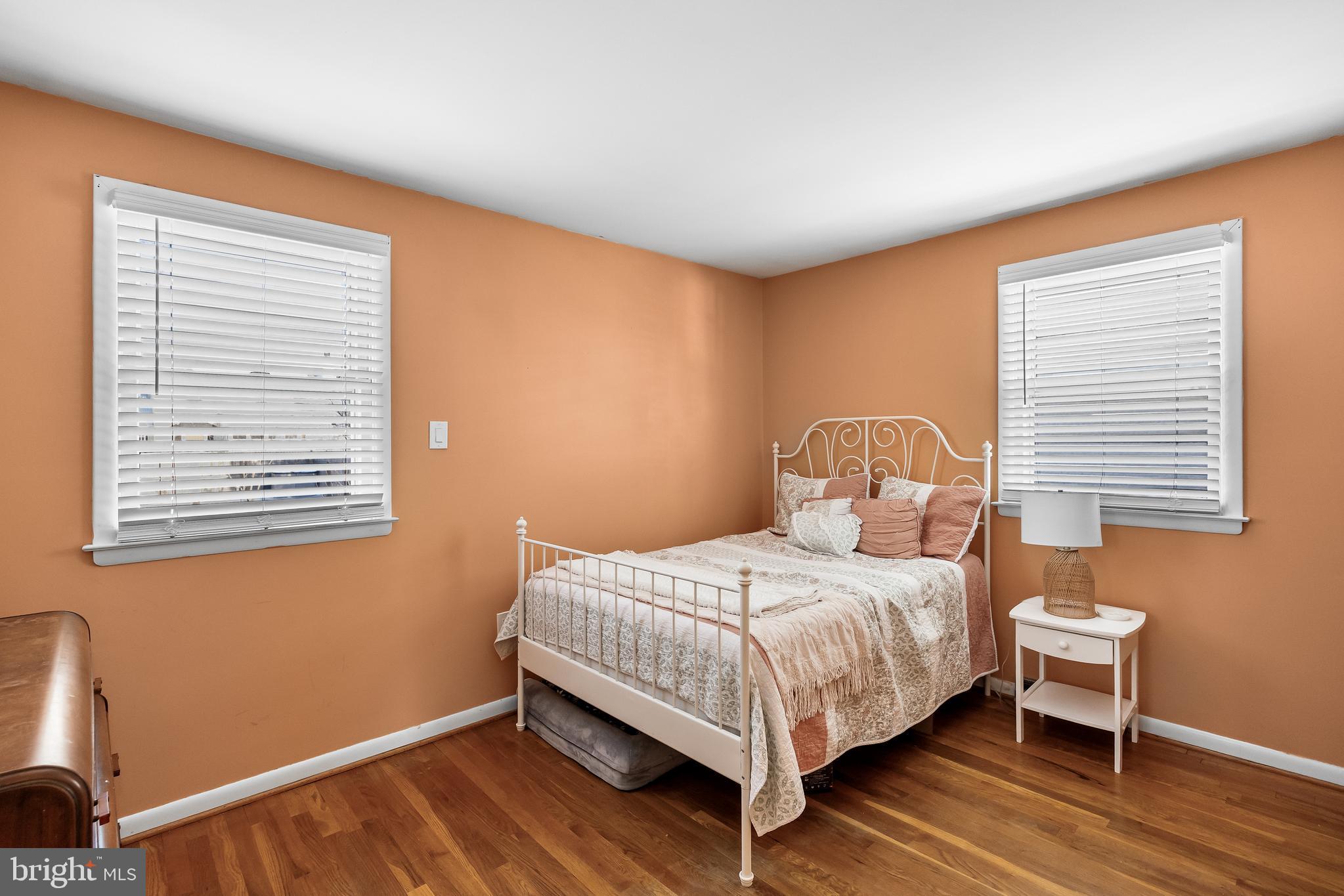 409 Lippincott Avenue Riverside, NJ 08075 - Photo 17 of 25 a bedroom with a bed wooden floor and window