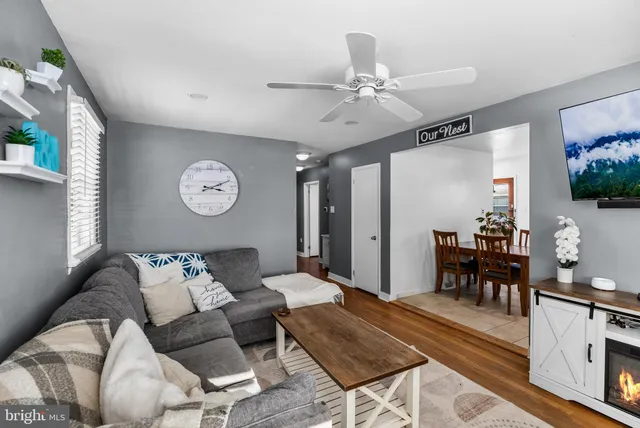 a living room with furniture and view of kitchen