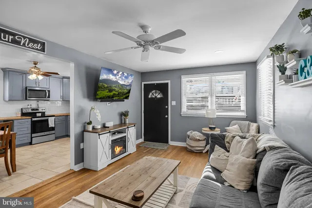 a living room with furniture flat screen tv and window