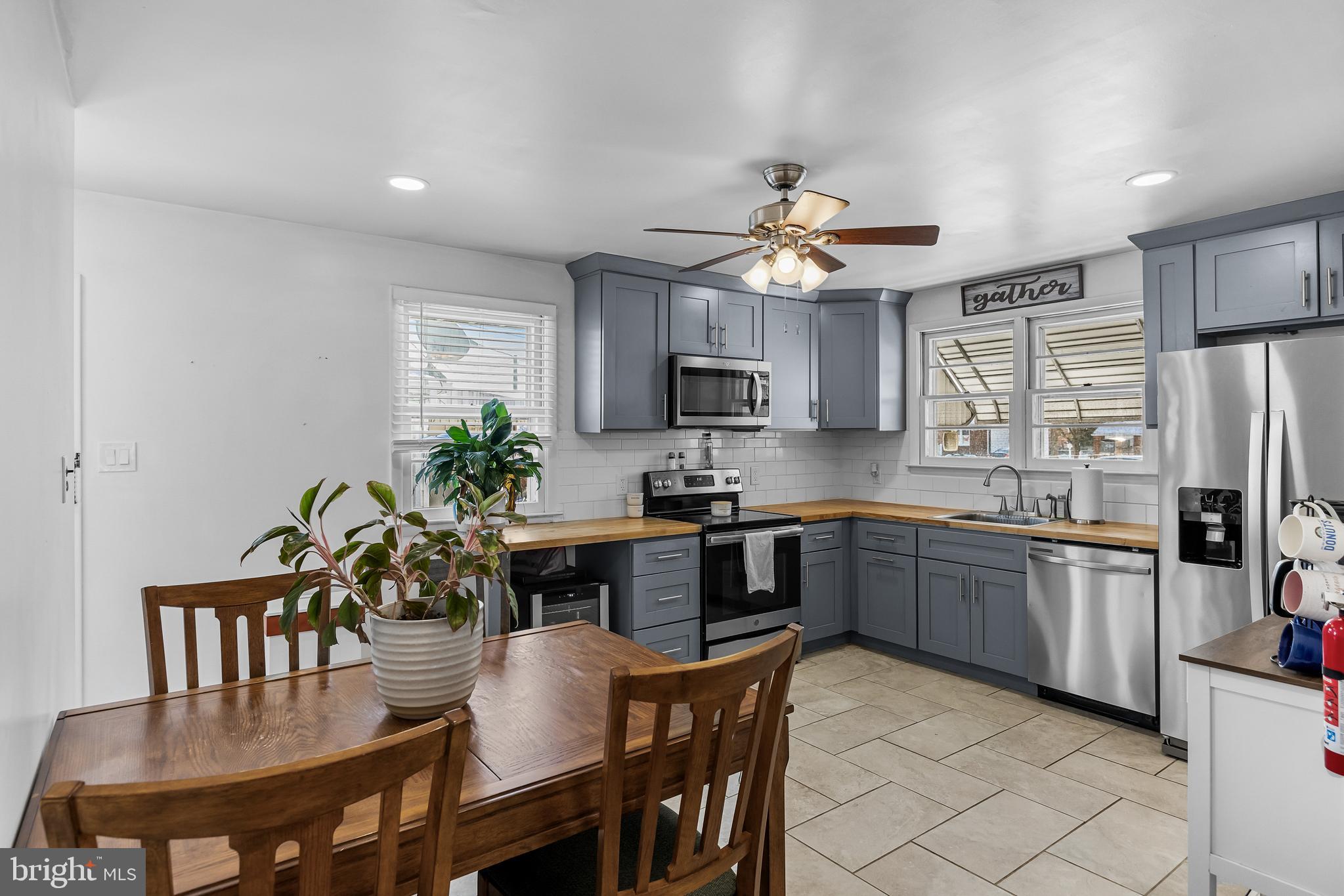 409 Lippincott Avenue Riverside, NJ 08075 - Photo 8 of 25 a kitchen with granite countertop stainless steel appliances a dining table and chairs