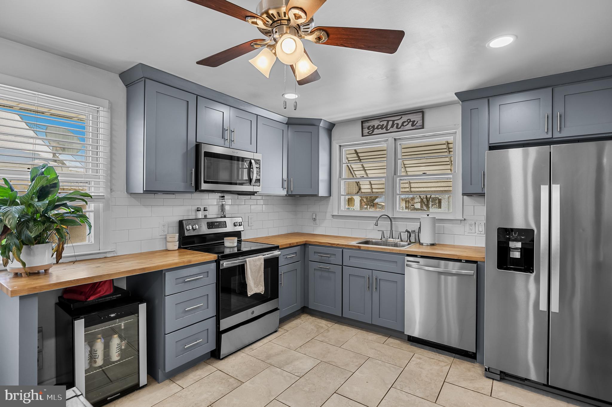 409 Lippincott Avenue Riverside, NJ 08075 - Photo 9 of 25 a kitchen with stainless steel appliances granite countertop a refrigerator a stove a sink a microwave and island