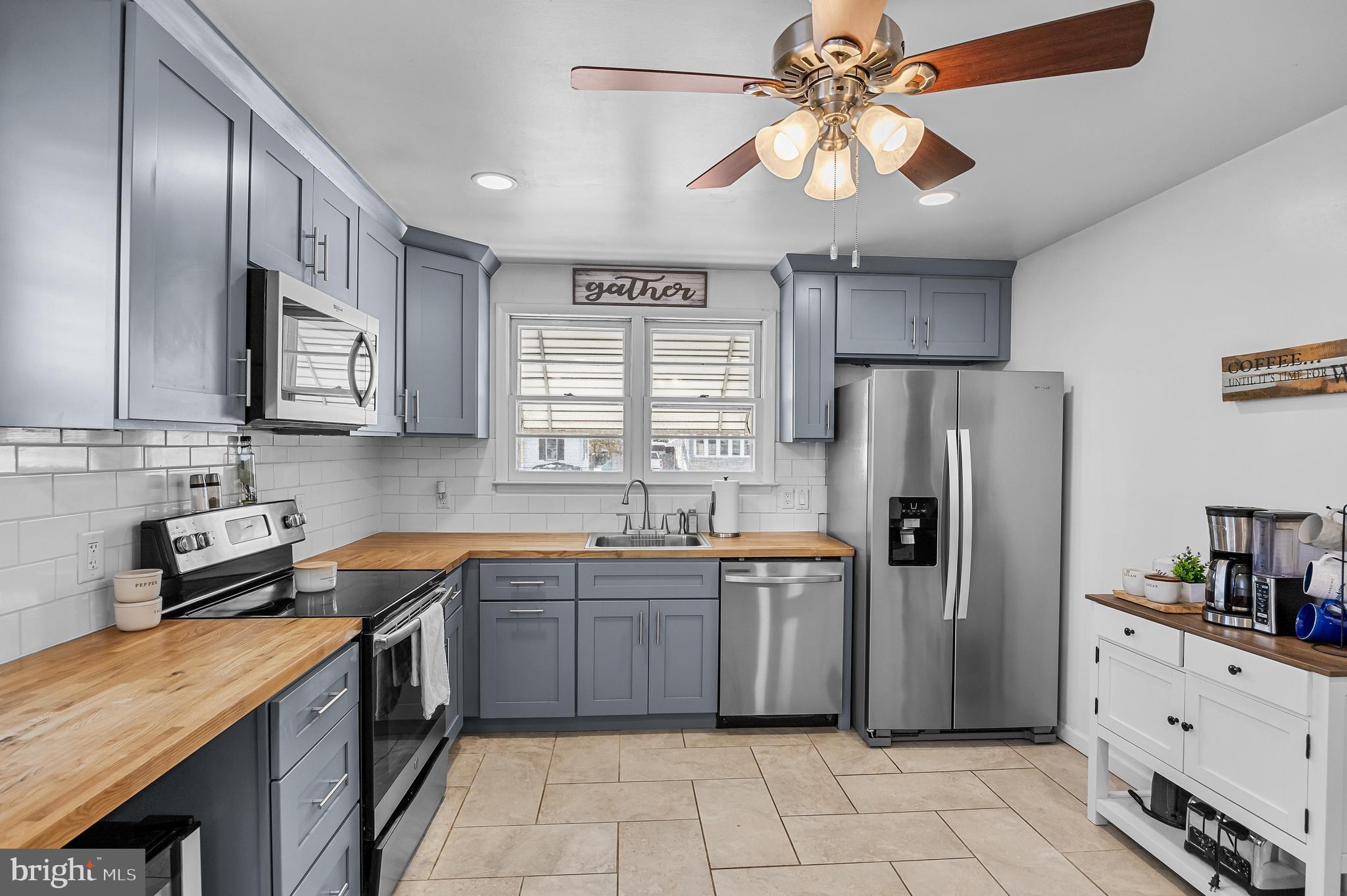 409 Lippincott Avenue Riverside, NJ 08075 - Photo 10 of 25 a kitchen with stainless steel appliances granite countertop a sink a stove a refrigerator cabinets and island