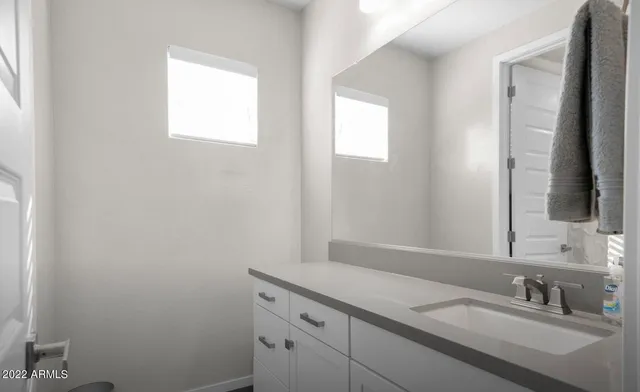 a bathroom with a sink and a mirror