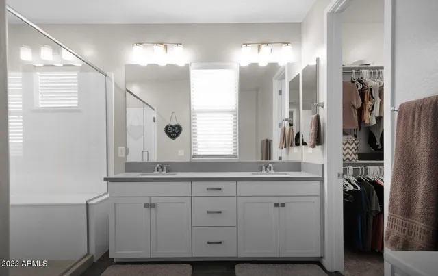 a bathroom with a double vanity sink and a mirror