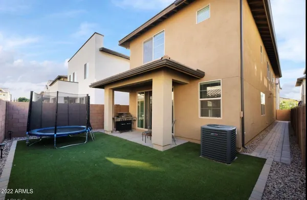 a view of a backyard with furniture potted plants and wooden fence