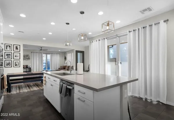 a kitchen with stainless steel appliances granite countertop a sink and a refrigerator