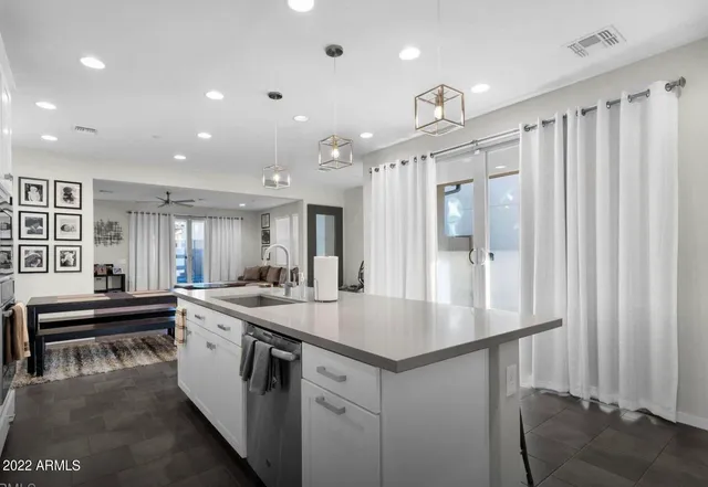 a kitchen with stainless steel appliances granite countertop a sink and a refrigerator