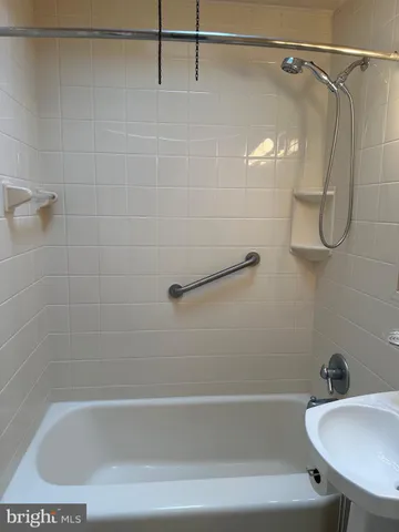 a bathroom with a bath tub with a shower
