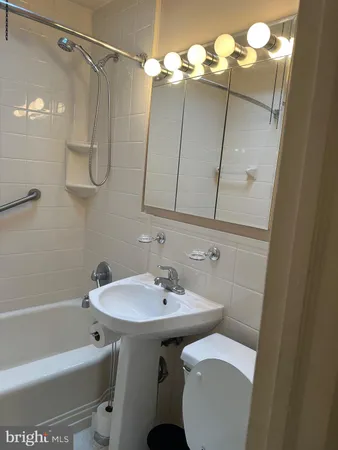 a bathroom with a sink a toilet and bathtub