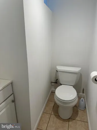 a white toilet sitting next to a shower