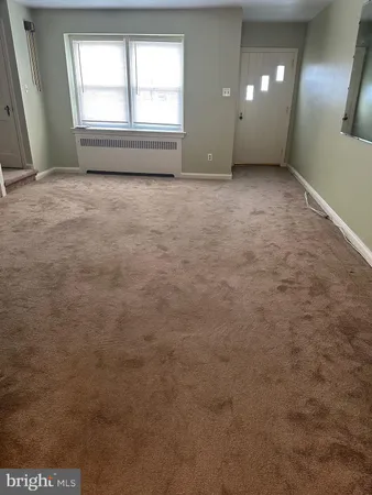 an empty room with a empty space and windows