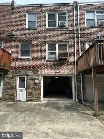 a front view of a house with a parking space