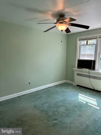 a view of room with window and ceiling fan