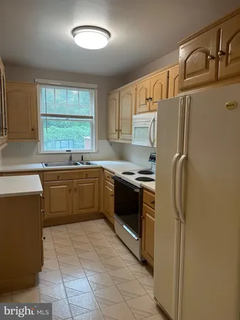 a kitchen with stainless steel appliances a refrigerator sink and cabinets