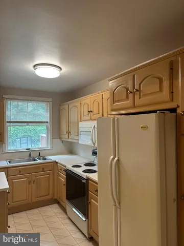 a kitchen with stainless steel appliances granite countertop a refrigerator sink and cabinets